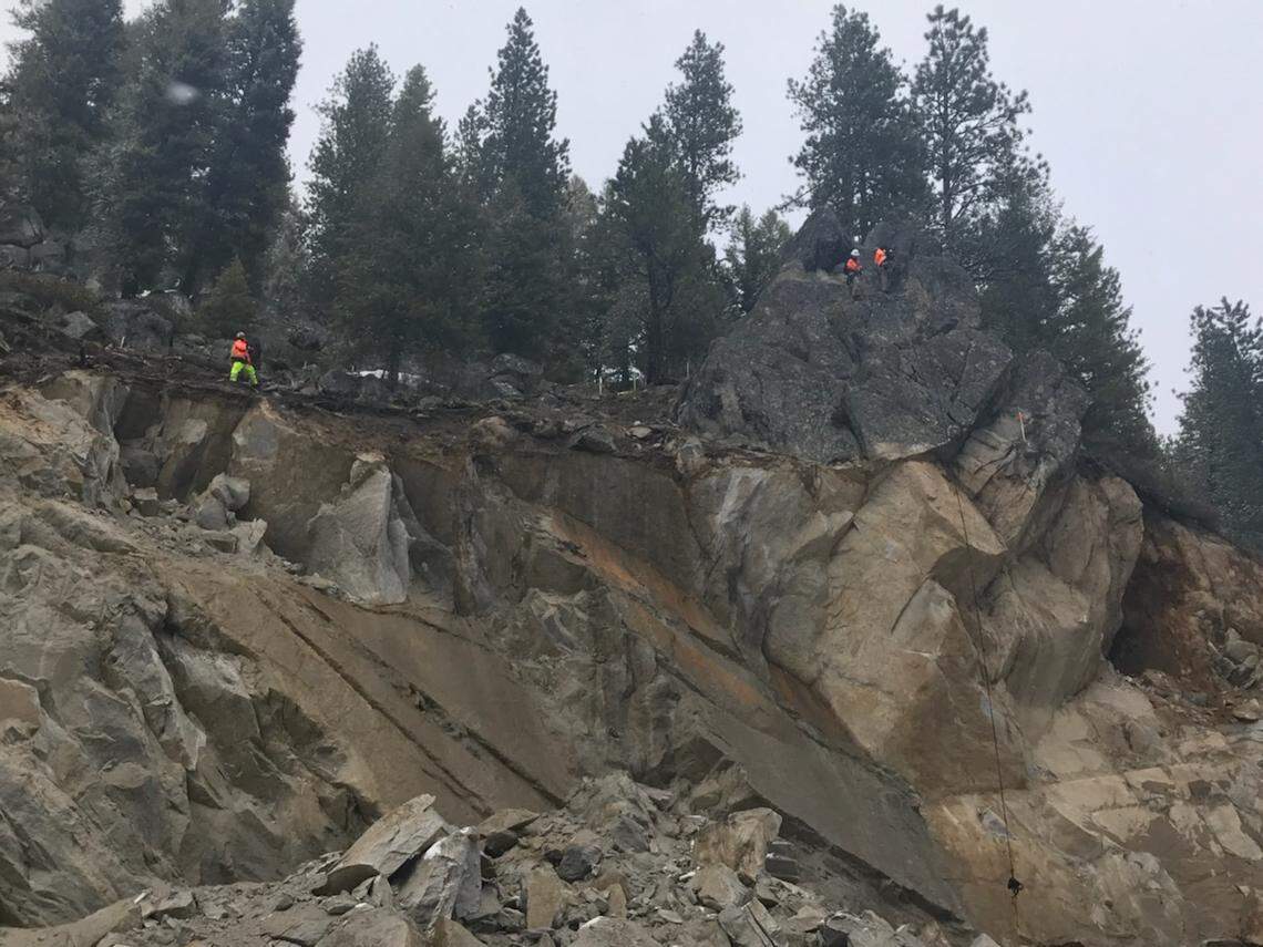 Experts examine the remaining outcropping near Smiths Ferry.