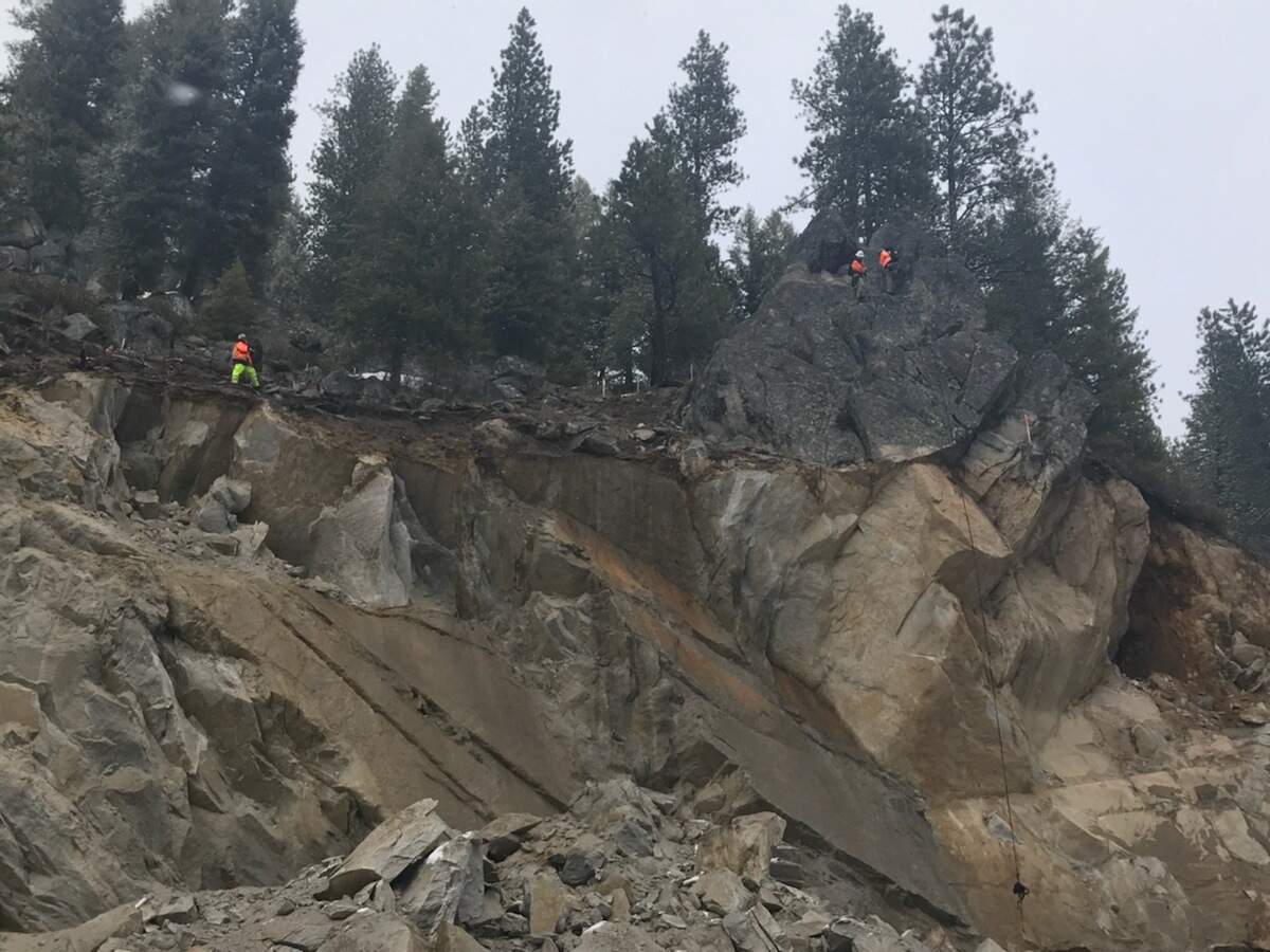 Experts examine the remaining outcropping near Smiths Ferry.