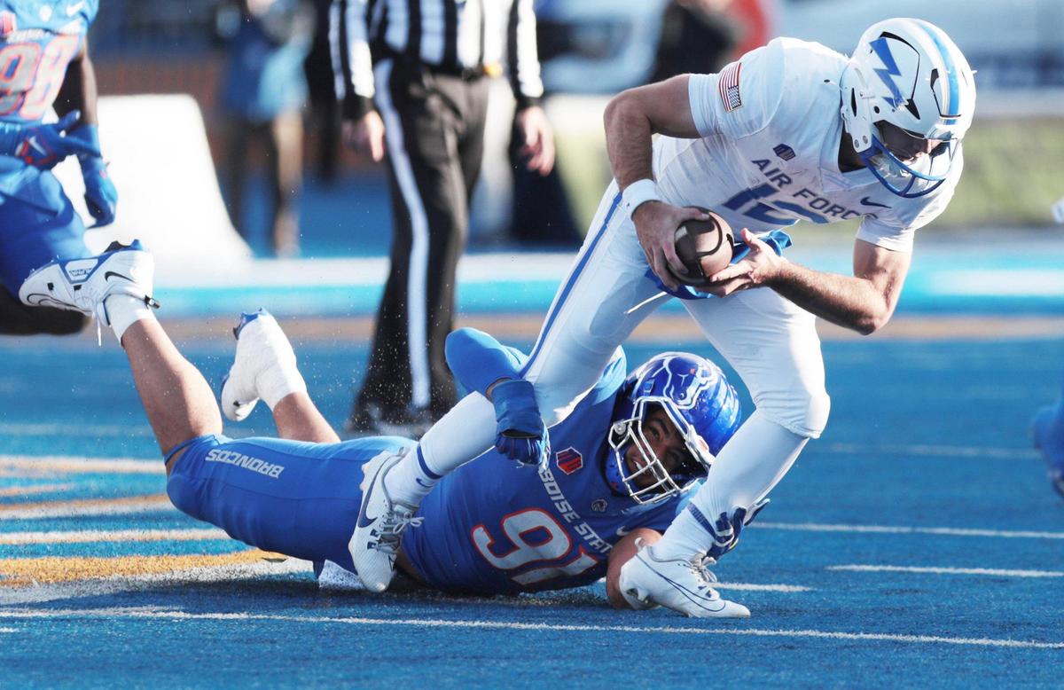 Boise State defensive end Ahmed Hassanein tackles Air Force quarterback John Busha during the game at Albertsons Stadium. Boise State defeated Air Force 27-19. Friday, Nov, 24, 2023.