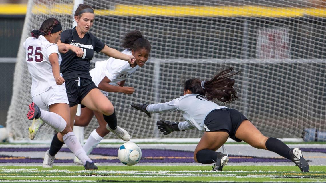 Centennial freshman Mia Sirokman scores into an open net after getting by Rocky Mountian goalkeeper Ellie Stoll and defender Ashley Wind on Thursday.