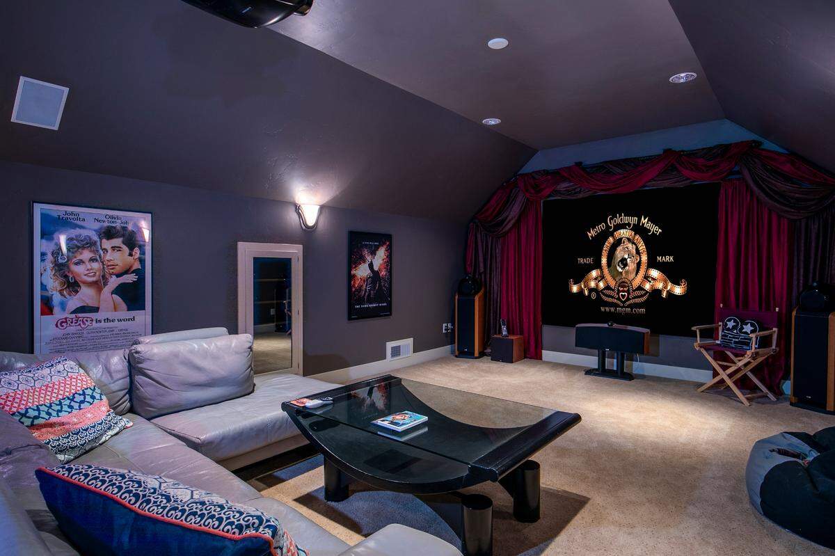 The 120-inch projector is accompanied by a Mitsubishi projector and Bowers and Wilkins speakers.