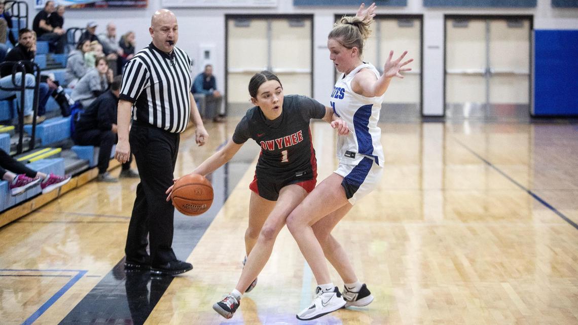 Owyhee sophomore Josie Davis dribbles around Timberline senior Piper Davis on Friday at Timberline. Davis scored seven of her 12 points in the fourth quarter as the Storm rallied for the win.