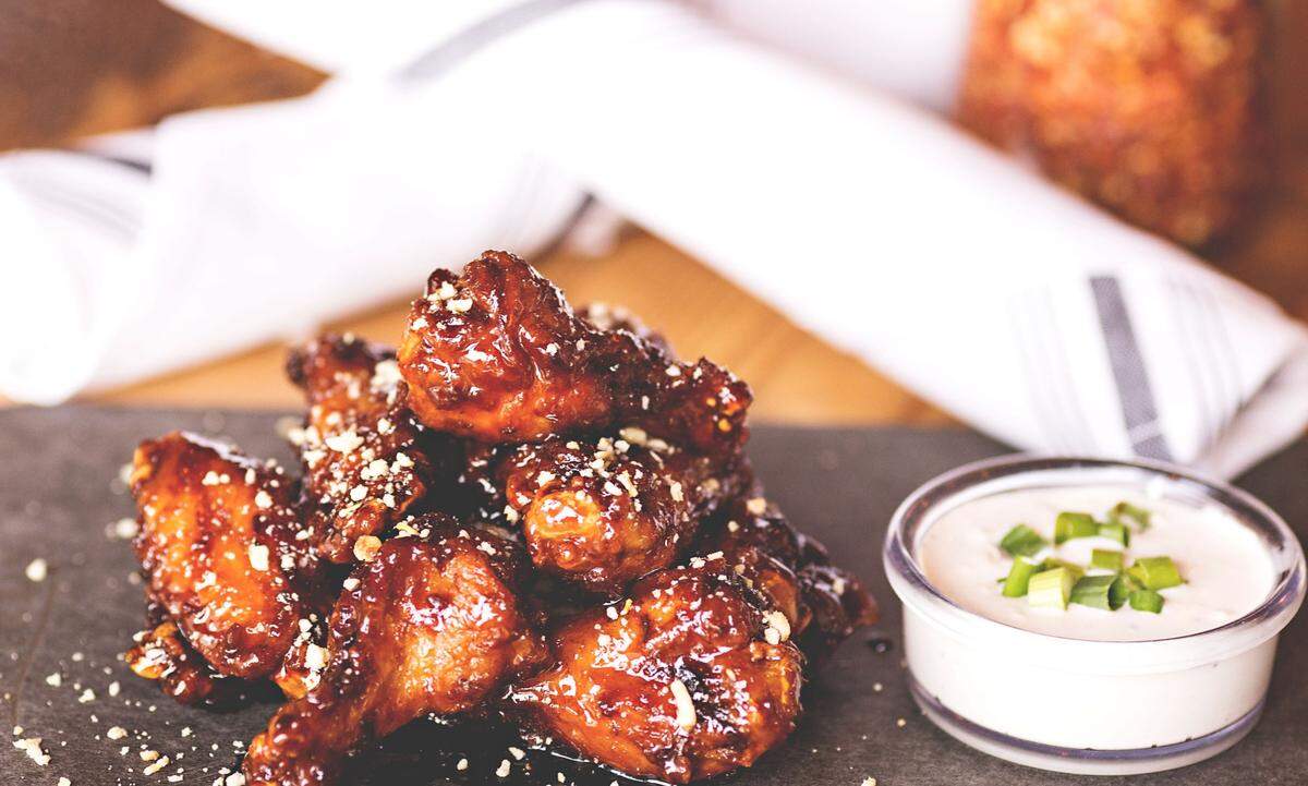 Balsamic glazed chicken wings ($18) are among 15 starters on the menu.