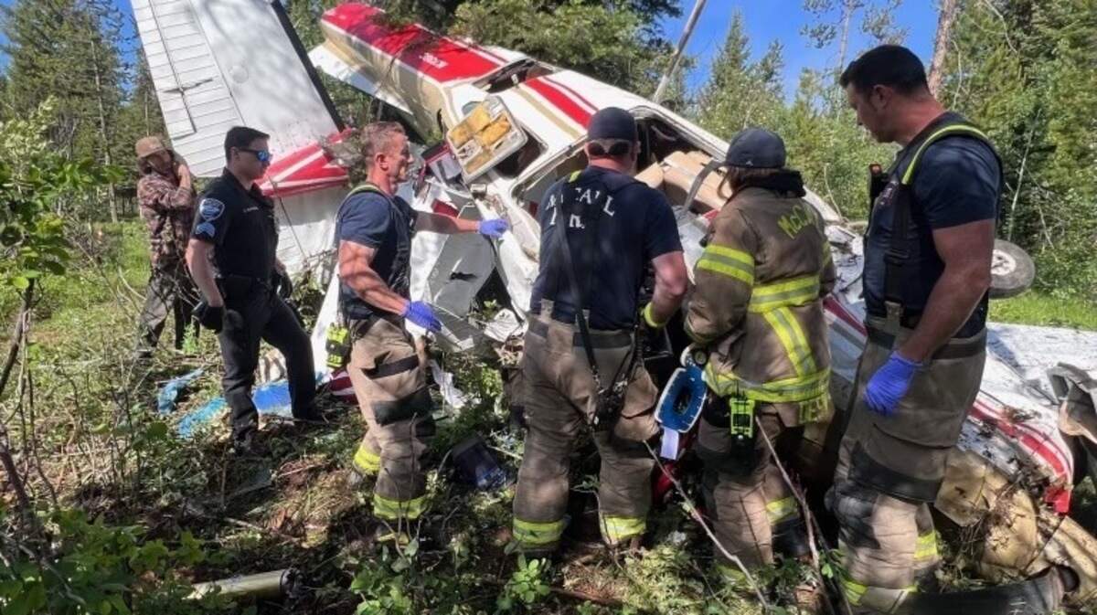 Firefighters work around the wreckage of a Cessna R182 that went down in the woods near a McCall playground on Monday morning.