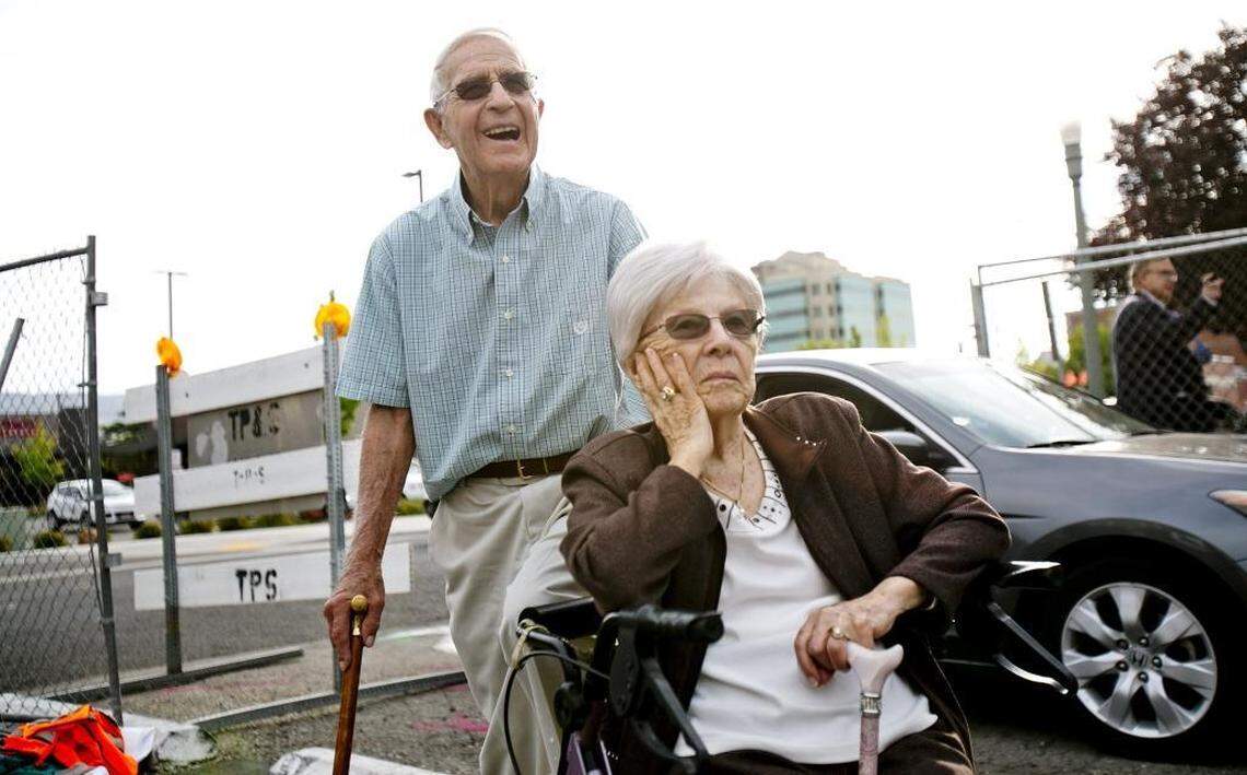 William K. Dunkley and wife Dorothy watch as son Mark (off-camera) uses an excavator to begin demolition on the Dunkley Music building in September 2015.