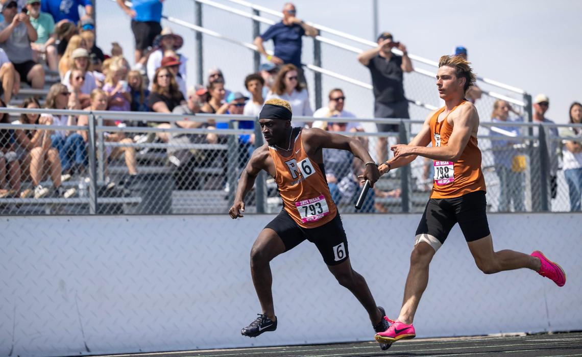 Ridgevue’s Caden Warren hands the baton off to Michael Kabika in the 4A boys 4x100-meter relay.