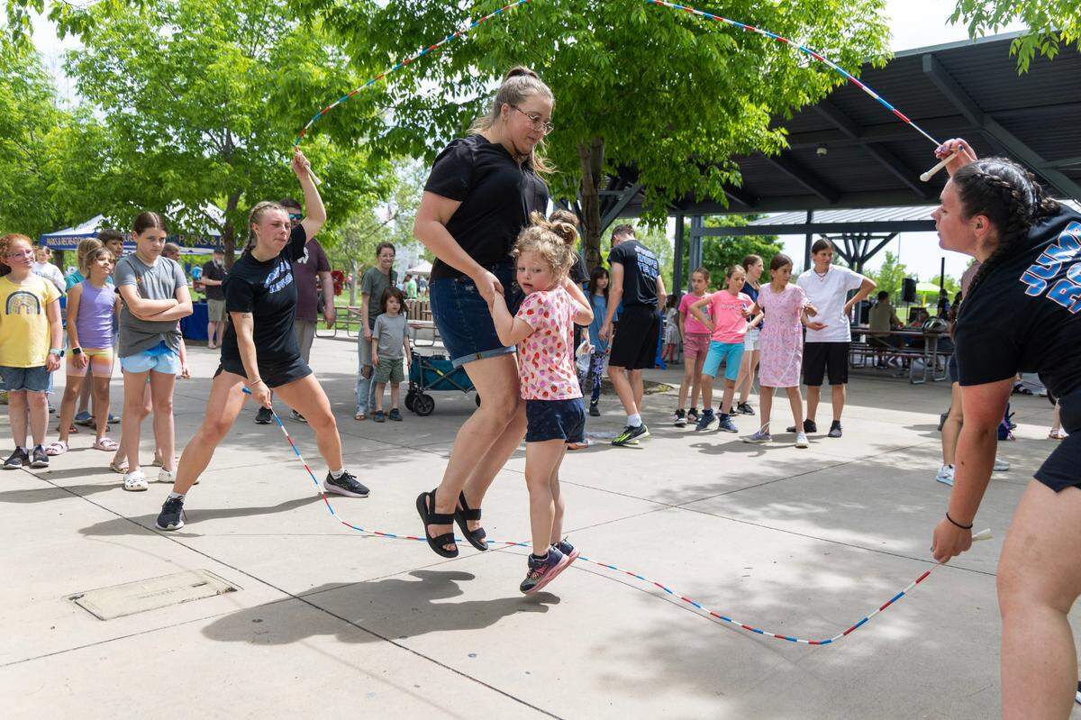 Geena Zenovieff and her daughter Emily Zenovieff, 4, practice double dutch with members of the Summerwind Skippers jump rope team at Kleiner Park on May 10, 2025, for the Unplug and Be Outside event sponsored by the Meridian Parks and Recreation Department. 
