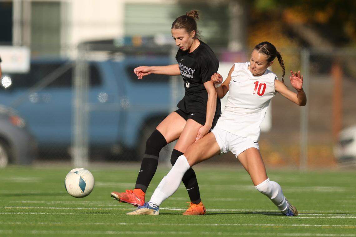 Rocky Mountain’s Van Staley and Boise’s Kohl Frazier compete for the ball during the 6A girls soccer state championship Saturday at War Memorial Field in Sandpoint.