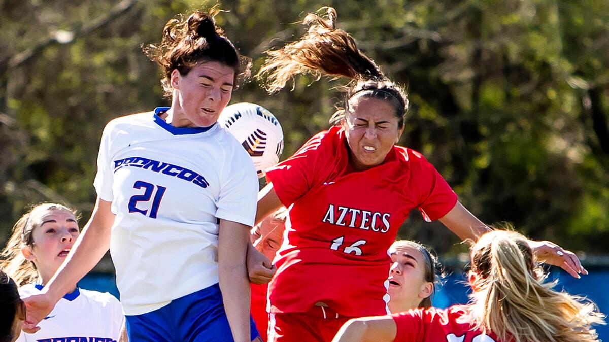 Boise State defender Macie Nelson and San Diego State midfielder Kiera Utush leap for an Aztec corner kick early in the first half Friday, April 9, 2021, at Boas Soccer Complex in Boise. BSU lost the Mountain West women’s soccer game 1-0.