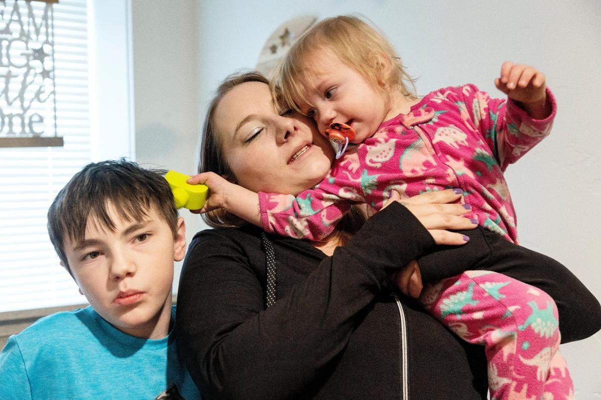 Katie Mengel, center, her son Kaydyn, 11, left, and daughter Lorelei, 1, rent a duplex in Nampa with assistance from Leap Housing.