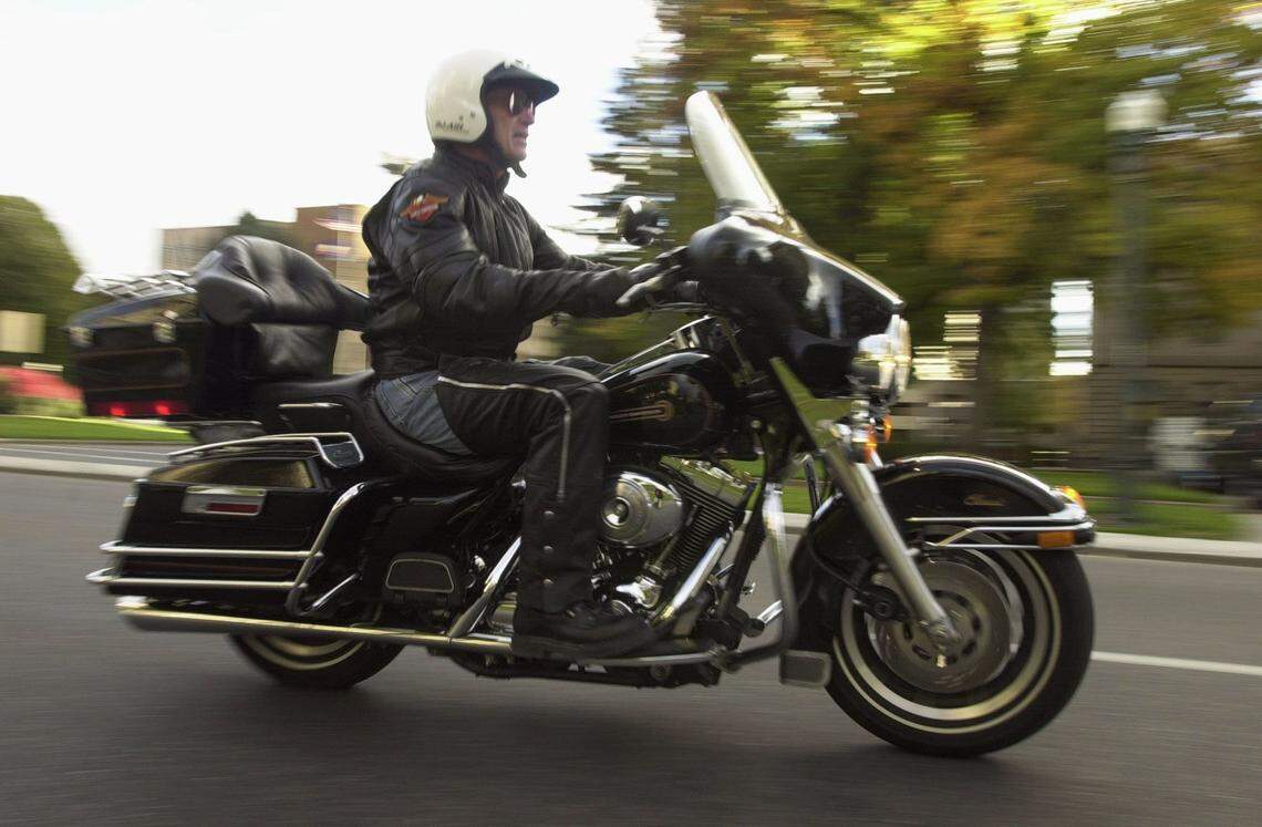 Idaho Gov. Dirk Kempthorne cruises through Boise on his Electra Glide Harley-Davidson motorcycle ahead of his 50th birthday in 2001.