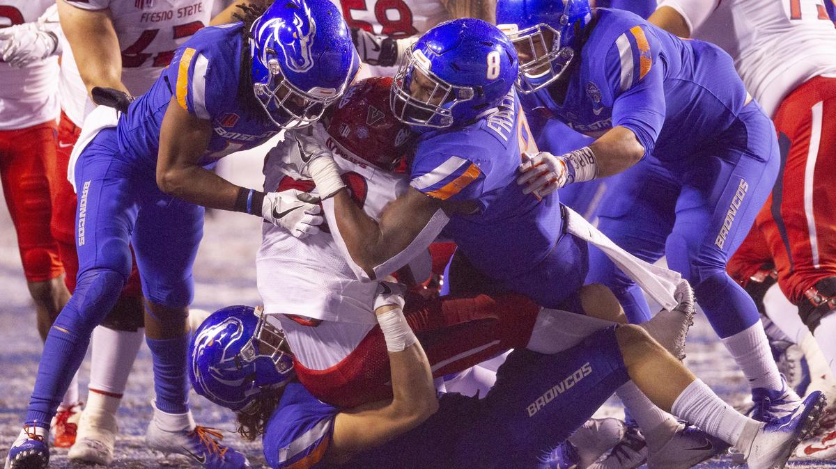 Boise State linebacker Jabril Frazier (8) and teammates make a goal-line stop on Fresno State running back Ronnie Rivers (20) in overtime during the Mountain West championship game at Albertsons Stadium. Fresno State defeated Boise State 19-16.