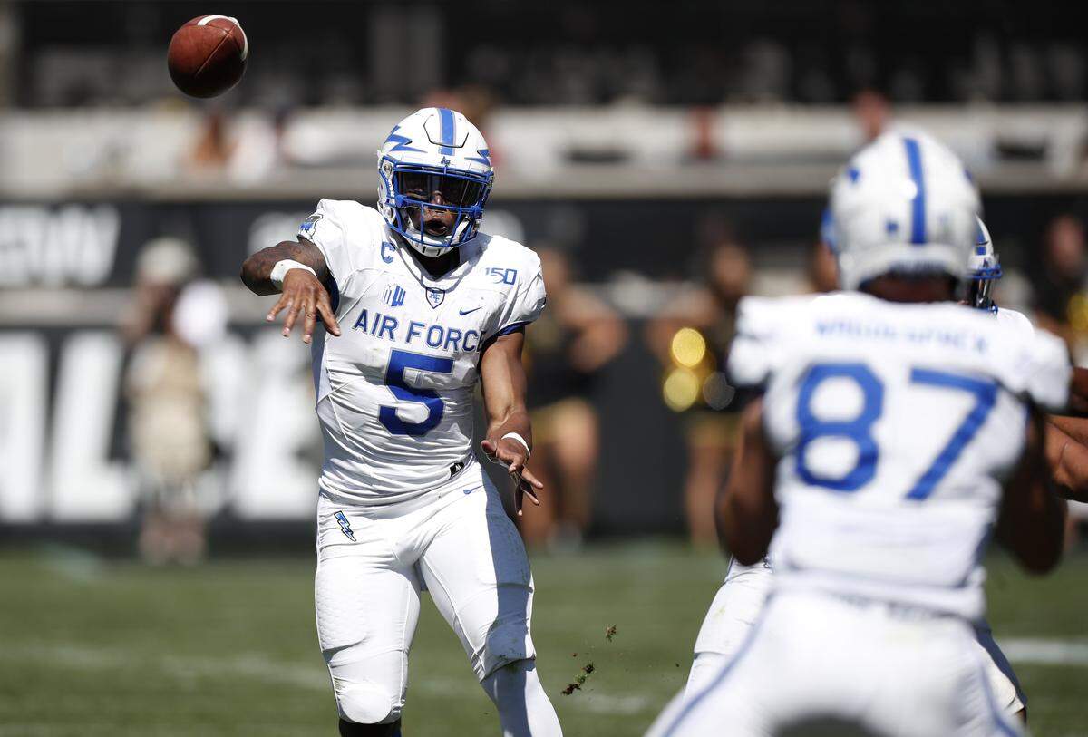 Air Force quarterback Donald Hammond III, back, throws a pass to tight end Kade Waguespack in the second half of an NCAA college football game against Colorado Saturday, Sept. 14, 2019, in Boulder, Colo. Air Force won 30-23 in overtime.