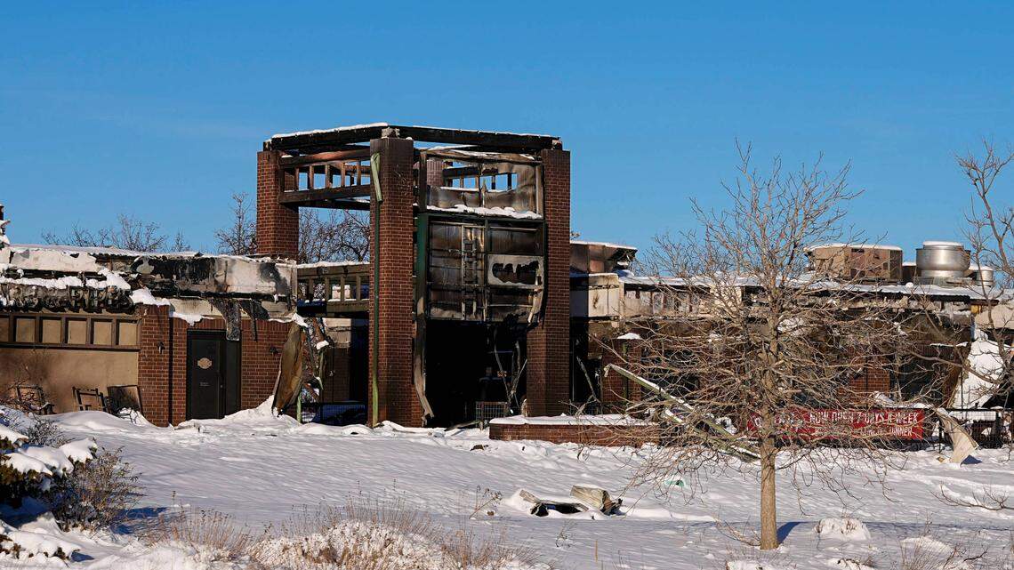 Snow covers the burned remains of a shopping center after wildfires ravaged the area Sunday, Jan.2, 2022, in Superior, Colo. Investigators are still trying to determine what sparked a massive fire in a suburban area near Denver that burned neighborhoods to the ground and destroyed nearly 1,000 homes and other buildings.
