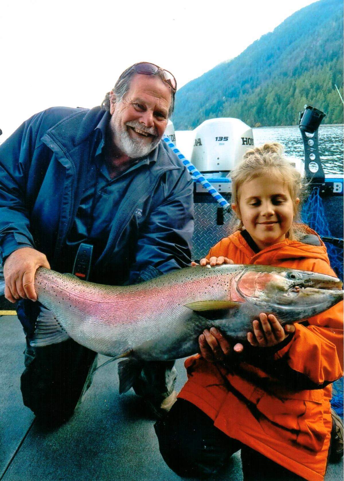Sophie Egizi, 8, of Sandpoint, Idaho, poses with her catch-and-release record-breaking Gerrard rainbow trout on Oct. 11, 2019. Egizi, who’s joined by Capt. Bob Wiley of Pend Oreille Charters, named the fish “Old Man Sparkles.”