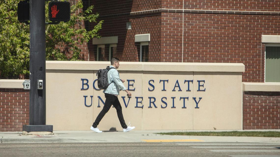 A students uses a the sidewalk at Boise State University on April 22, 2021. Idaho’s public colleges and universities have lost more than 5,000 students since the pandemic.