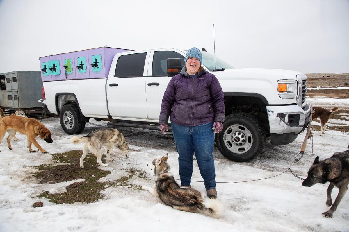Dog sled musher Liz Nevills of Middleton gets supplies, including nine dogs, ready for a practice run at a nearby Bureau of Land Management site on Jan. 19, 2022. Without adequate snow, she is still able to practice a dry land route on the land with the canines pulling her on an ATV. She recreates and competes under the name Miracle Sled Dog Team.