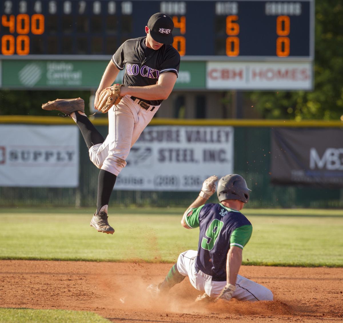 Rocky Mountain second baseman Michael Callister leaps over Mountain View's Riley Harrison as Harrison steals second base during Game 2 of the 5A district championship series.