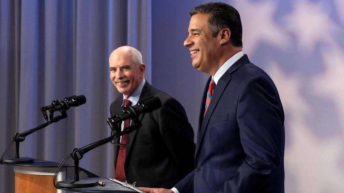 Idaho Attorney General candidates Tom Arkoosh, Democrat, and Raúl Labrador, Republican, share a laugh during their televised debate in this 2022 file photo.