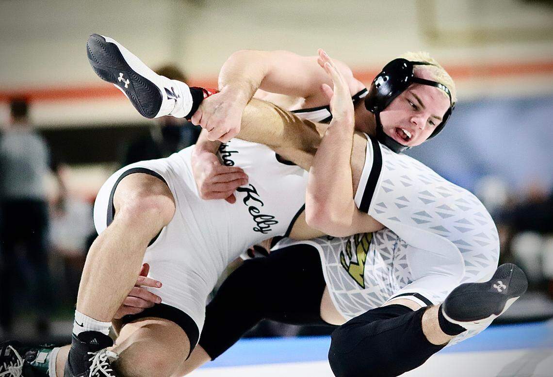 Bishop Kelly’s Jadon Skellenger flips Minico’s Paxton Twiss on Saturday during their 160-pound championship bout at the ICCU Dome in Pocatello.