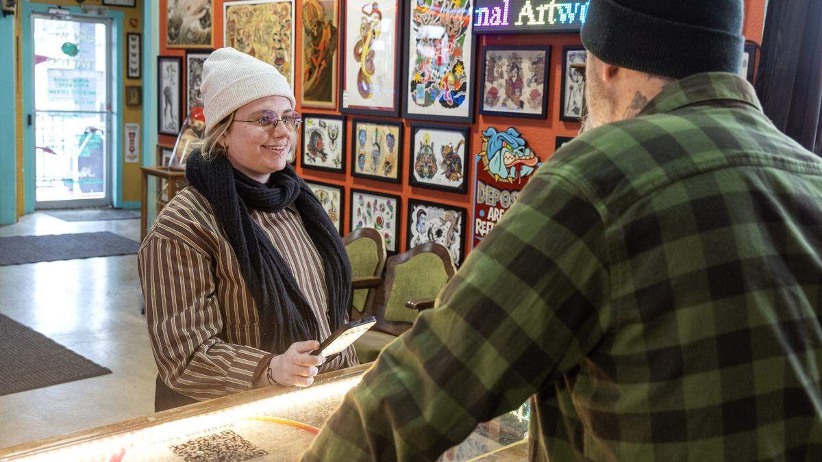 Idaho Statesman reporter Hali Smith, left, interviews the owner of Born Weird, a tattoo and piercing shop in Boise.