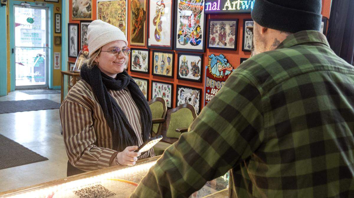 Idaho Statesman reporter Hali Smith, left, interviews the owner of Born Weird, a tattoo and piercing shop in Boise.