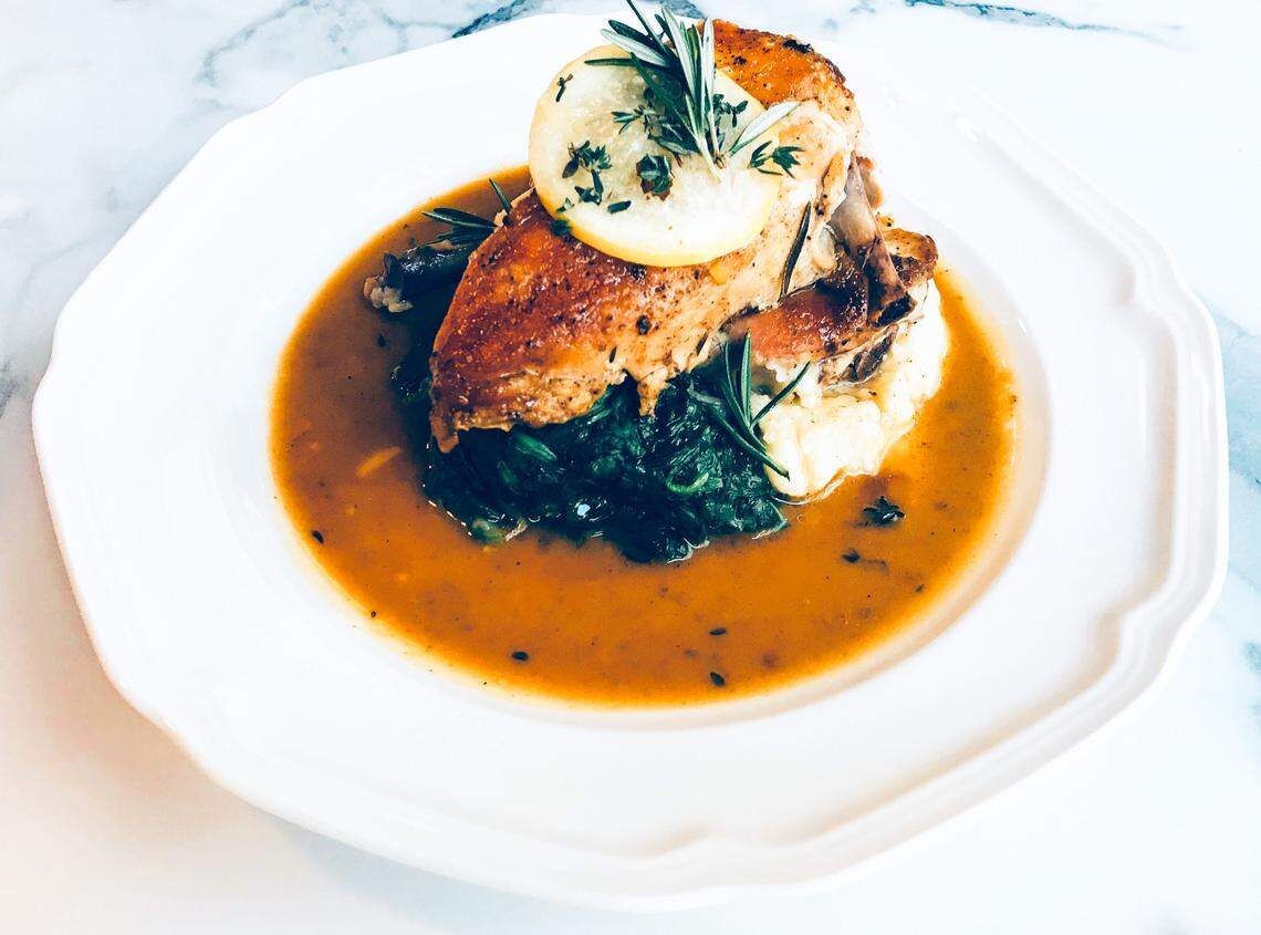 Mary’s Organic Half Roasted Chicken is served with potato puree, sauteed spinach and pan jus.
