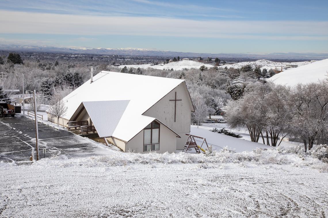 This church has just been torn down to make way for houses at this site on the northeast corner of Bogus Basin Road and Curling Drive. This view looks southeast. Bogus Basin Road is down the hill at center right.