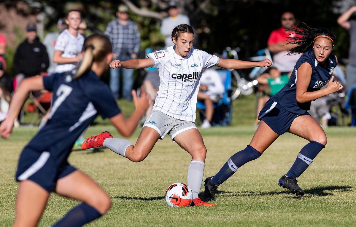 Catherine Carpenter of Idaho Rush, center, takes a kick as they play Wasatch SC (Utah) in the U-15 girls final of the US Youth Soccer Far West Regional Championships at Simplot Sports Complex in Boise on Sunday.