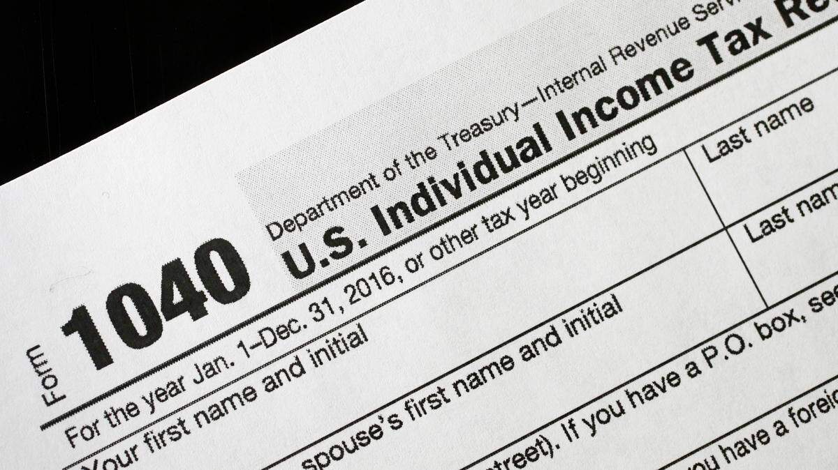A 1040 tax form appears on display, Tuesday, Jan. 10, 2017, in New York. (AP Photo/Mark Lennihan)