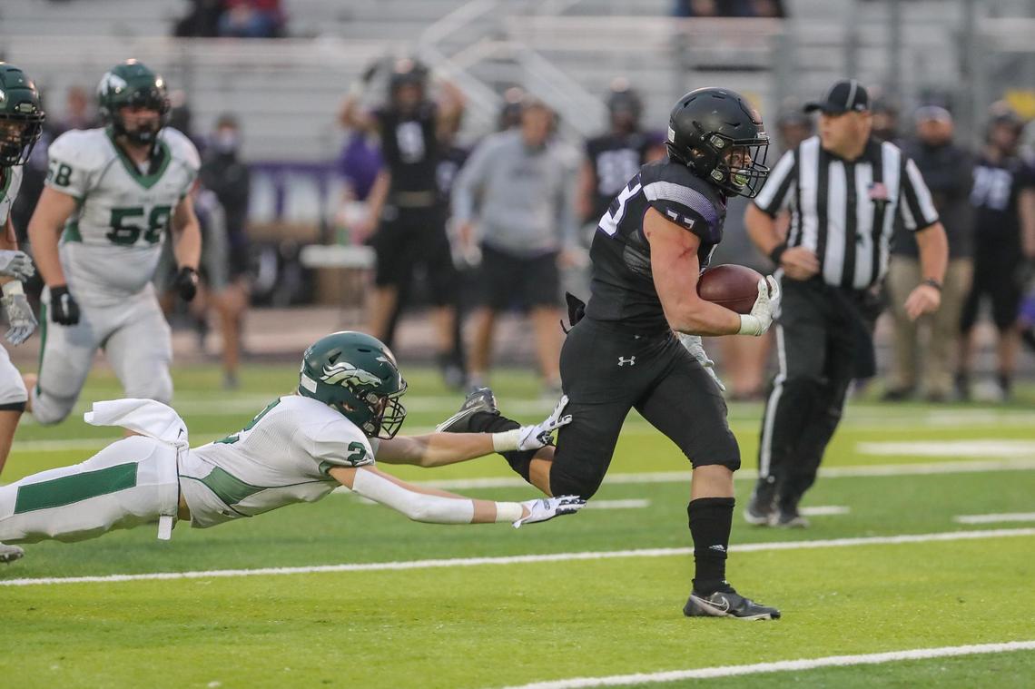 Rocky Mountain running back Maxwell Lehman breaks a tackle attempt by Eagle defensive back Gage Jones to score the only touchdown of the first half Friday.