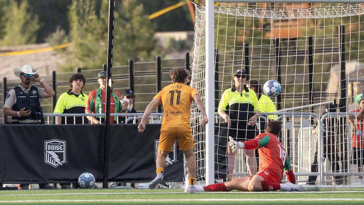 Fort Wayne FC midfielder Taig Healy, left, scores a goal on AC Boise goalkeeper Jonathan Kliewer during their soccer match, Saturday, May 23, 2026, at Athletic Club Boise Stadium. Fort Wayne FC defeated AC Boise 3-1.