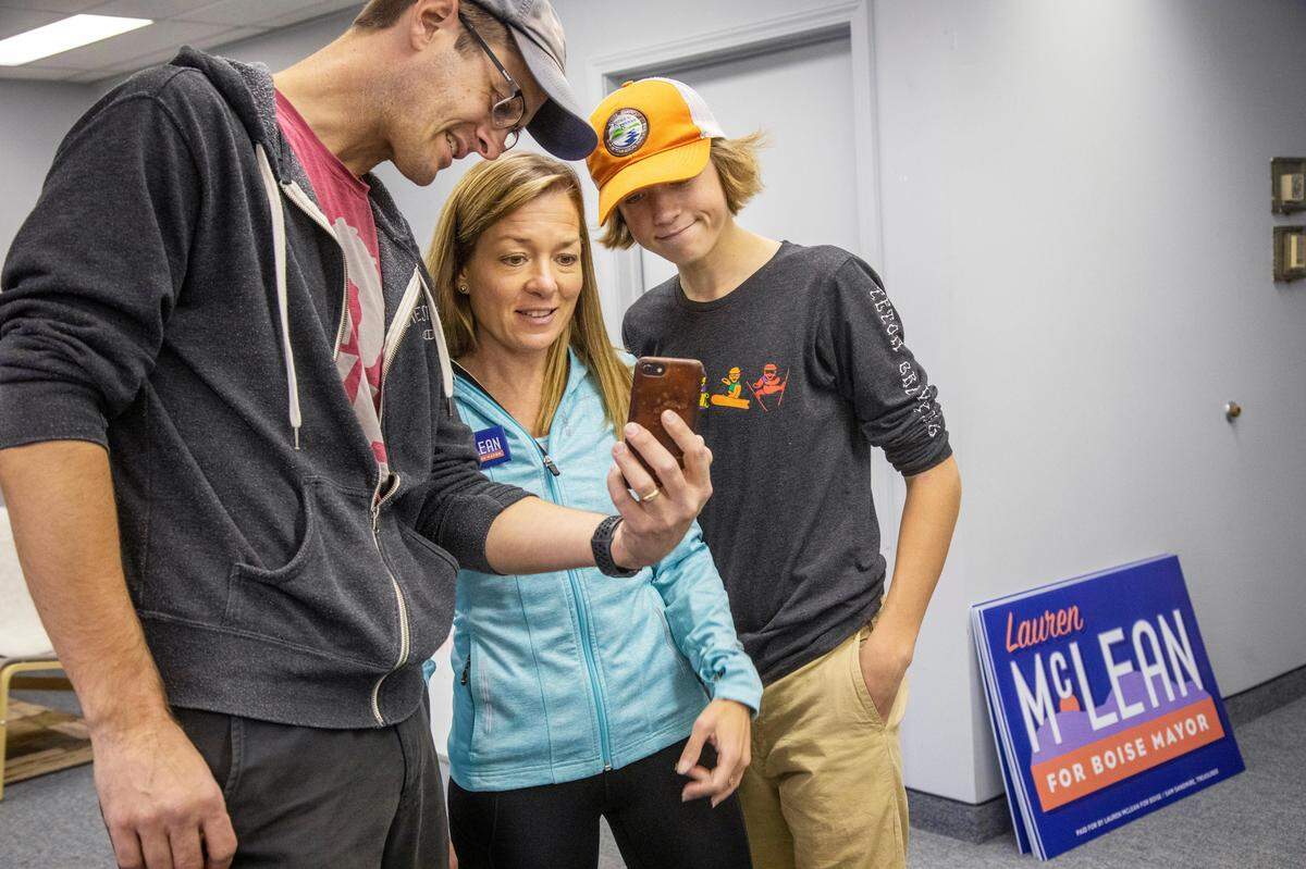Lauren McLean’s husband, Scott McLean, left, and son Aiden McLean, 15, stopped by campaign headquarters so the family could connect on Facetime with their daughter and sister Madeleine McLean, a college sophomore studying in Scotland.