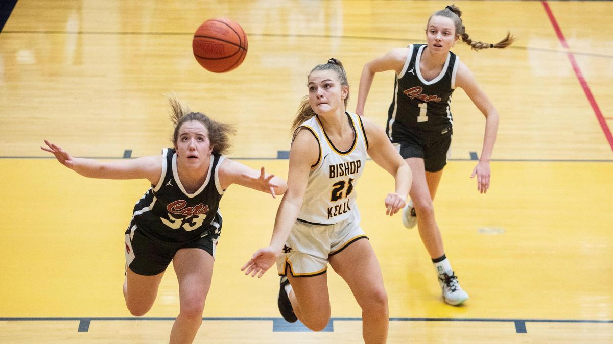 Columbia junior Maggie Mills, left, and Bishop Kelly junior Caroline Knothe battle for a loose ball Tuesday during the 4A District Three Tournament semifinals. Bishop Kelly won 42-29 to advance to state for the first time since 2018.
