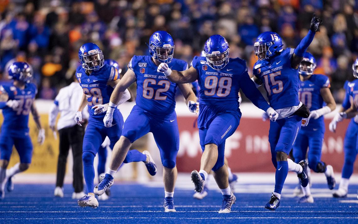 Boise State nose tackle Sonatane Lui (98) high-steps off the field with the Bronco defense after gathering his second New Mexico fumble Saturday at Albertsons Stadium.