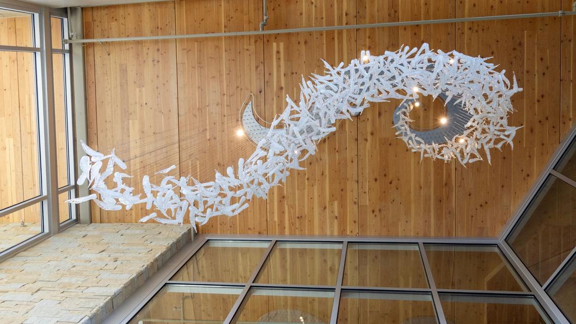 A glass artwork by Idaho artist Filip Vogelpohl named “Conscious Flight” is installed on the ceiling inside the Wassmuth Center for Human Rights’ new Philip E. Batt building.