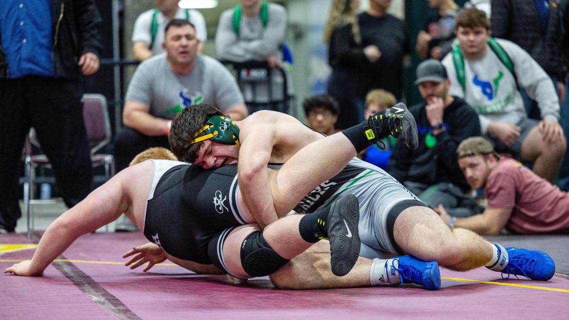 Mountain View’s Shilo Jones, top, works for a takedown against Wasatch’s Austin McNaughtan in the 285-pound championship Saturday at the Rollie Lane Invitational at the Ford Idaho Center in Nampa.