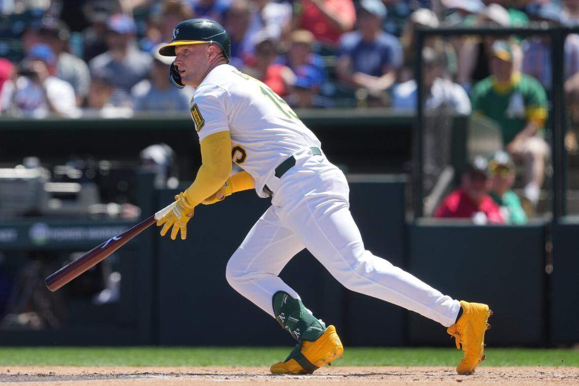 Apr 13, 2025; West Sacramento, California, USA; Athletics center fielder Seth Brown (15) hits a single against the New York Mets during the second inning at Sutter Health Park. Mandatory Credit: Darren Yamashita-Imagn Images