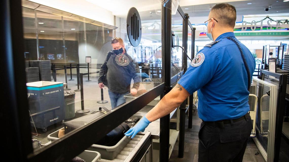TSA Officer Carlos Valadez guides Boise Airport travelers through new screening protocols that minimize contact during the coronavirus pandemic.
