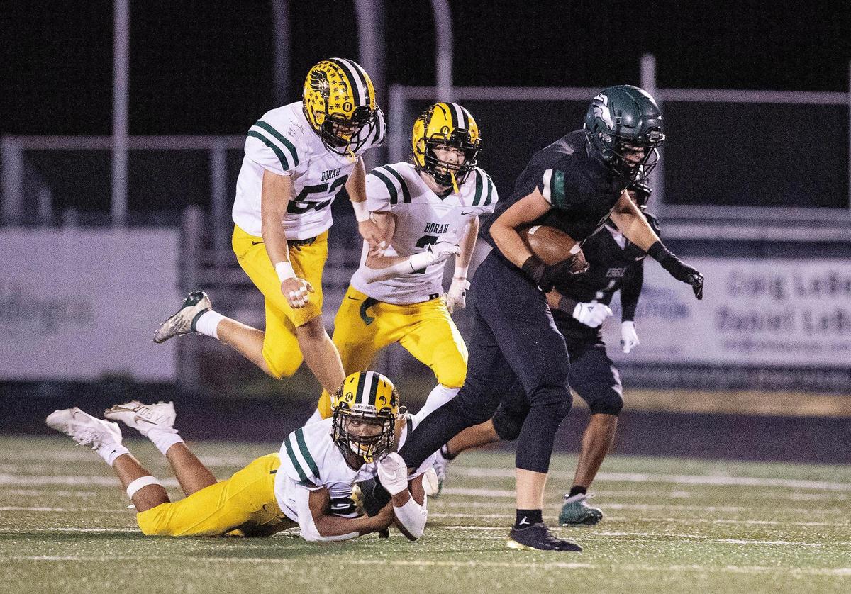 Eagle tight end Donovan Jones drags a Borah defender upfield on Oct. 29 during the first round of the 5A state playoffs. The Mustangs (9-2) host Highland (9-2) in the semifinals a 7 p.m. Friday.