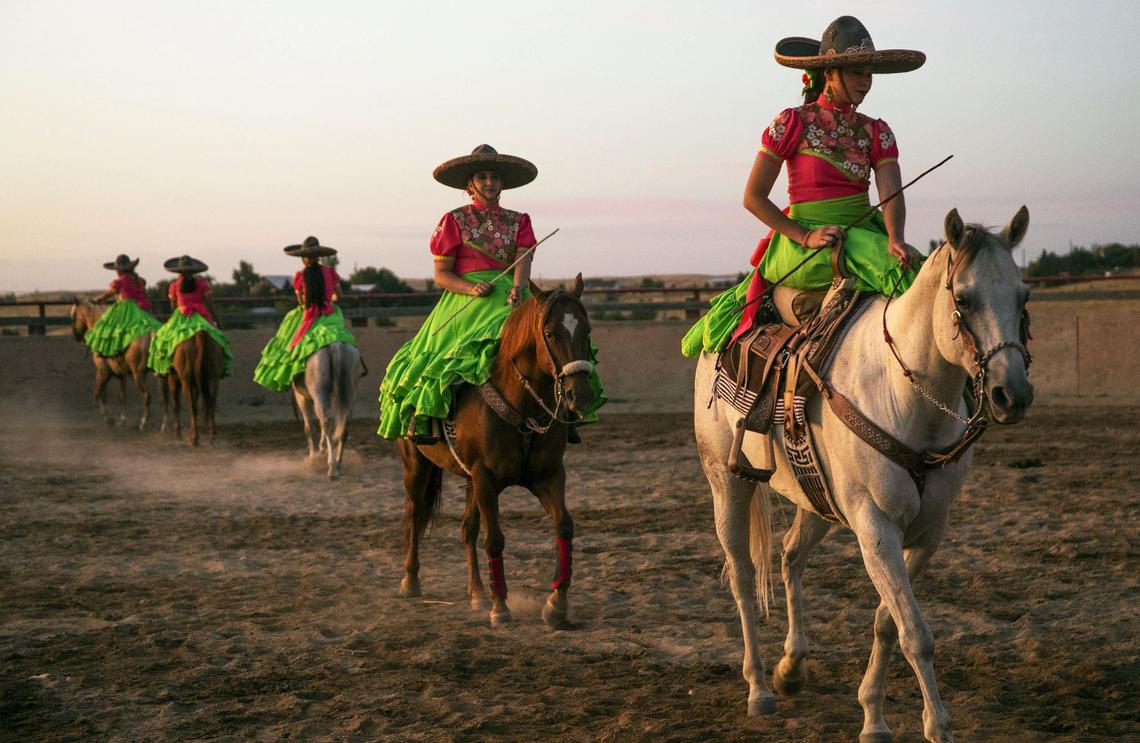 Escaramuza Charra Sueño Dorado walks through the choreographed routine before riding at a faster pace. The precision riding team practices often to make sure the team is comfortable with the maneuvers.