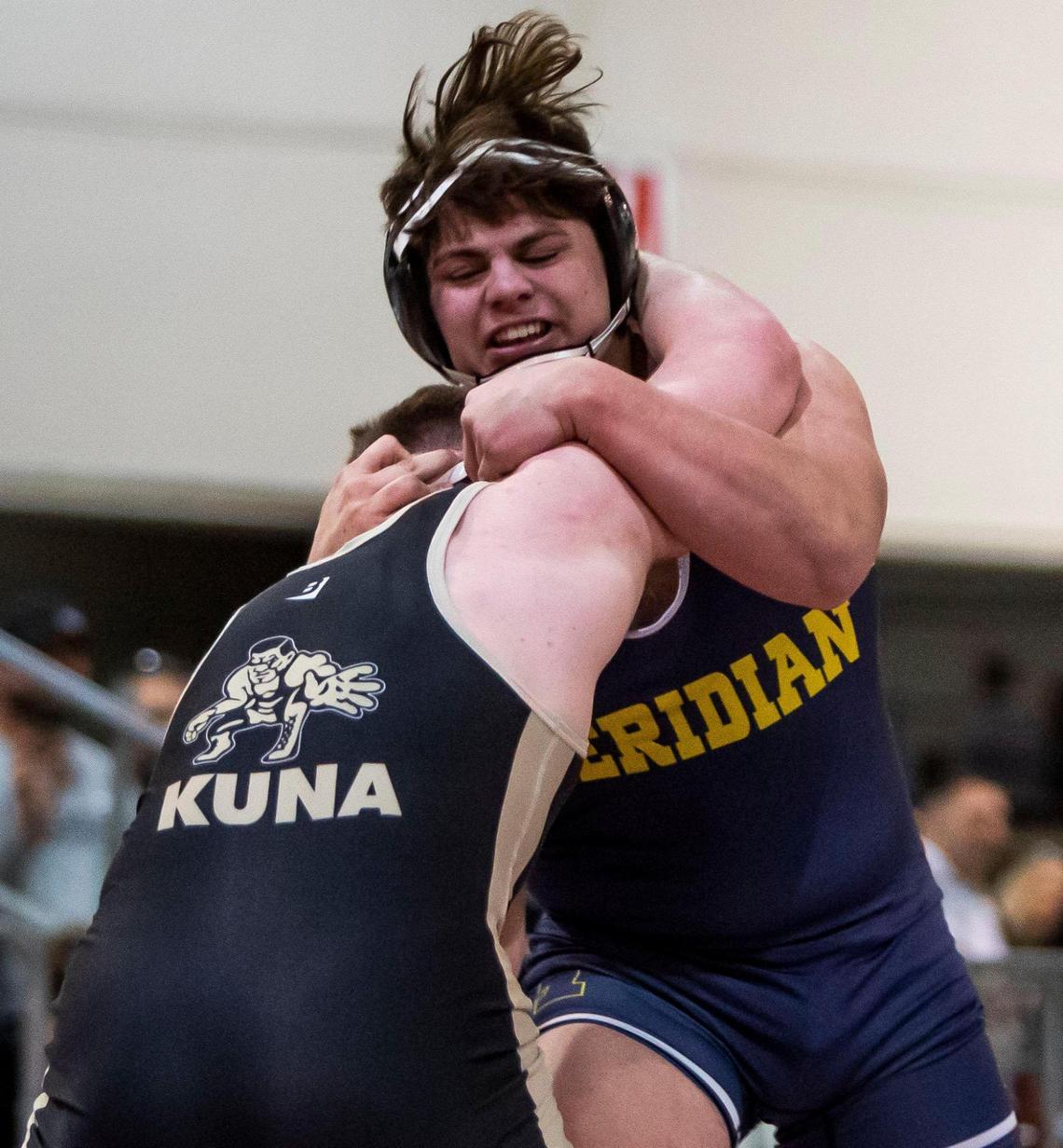 Carson Gooley, Meridian, grapples with Kuna’s Kody Biggs in the 195-pound 5A District Three championship match last season at Expo Idaho in Garden City. Gooley won the title with a 5-2 decision.