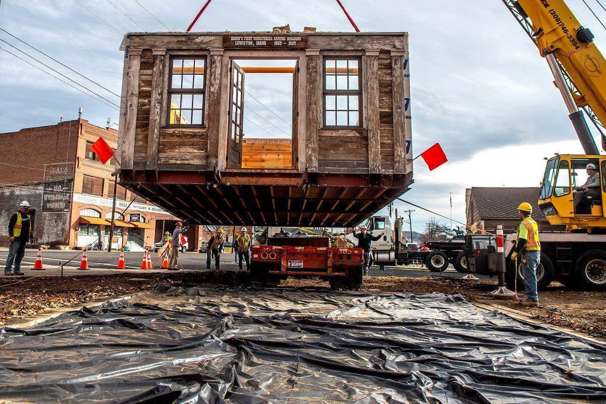 The replica of Idaho’s first Territorial Capitol building in Lewiston is lifted by a crane while a flatbed truck stands by to move it to its new location at the Nez Perce County Historical Society and Museum in Lewiston.