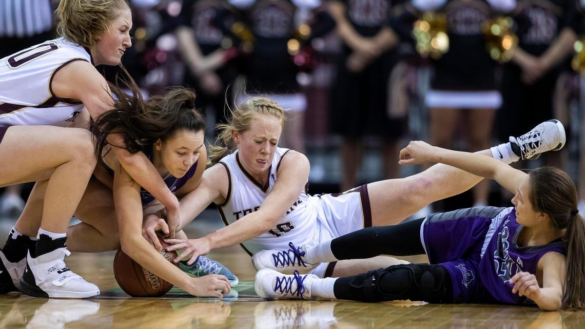 Rocky Mountain’s Marli Reed, second from left, grabs a loose ball during the 2020 5A state tournament.