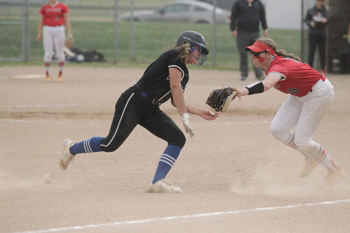 Owyhee third baseman Grace Brooks tags out Kyndal Bridge of Coeur d’Alene in a rundown to end the third inning Thursday in their first-round state tournament game at Post Falls High.