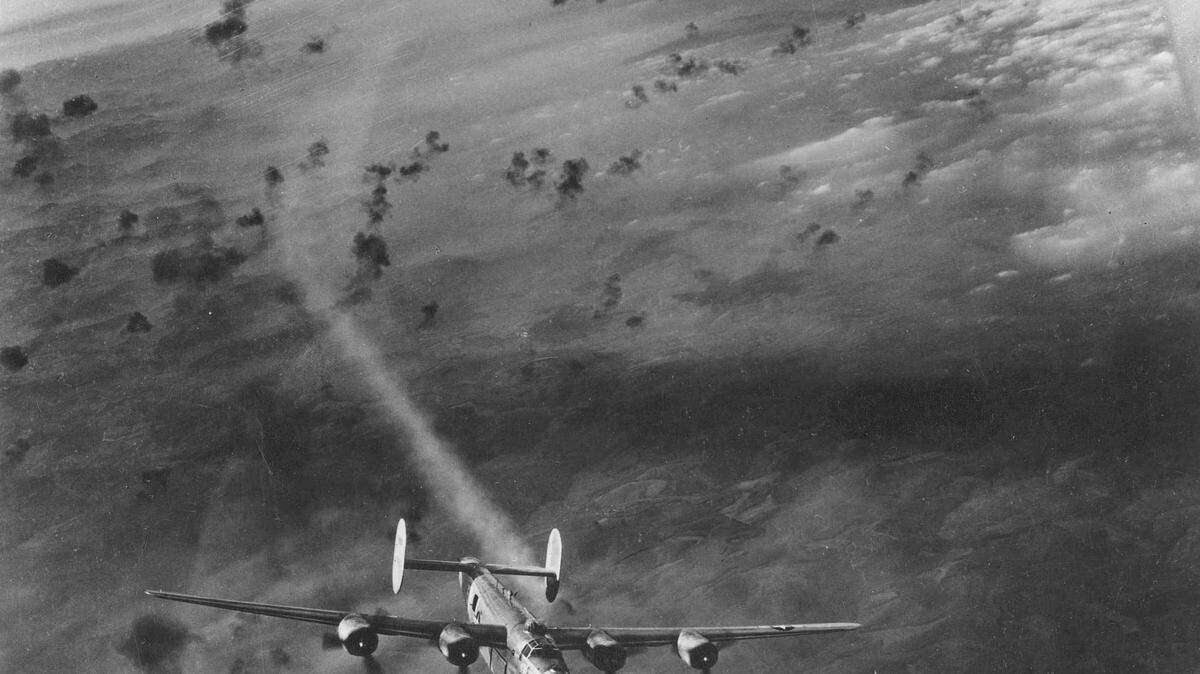 Consolidated B-24 emerges from flak area with its No. 2 engine smoking. (U.S. Air Force photo)