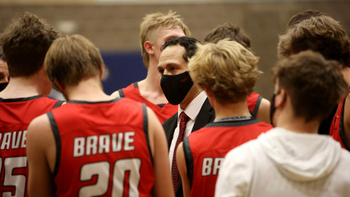 Boise boys basketball coach Manny Varela addresses his team during a timeout Tuesday at Mountain View High School in Meridian.