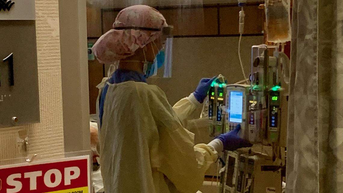 A nurse cares for a COVID-19 patient recently in the ICU at West Valley Medical Center in Caldwell.