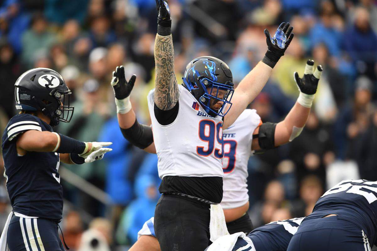 Boise State defensive lineman Scott Matlock signals touchdown on an offensive play during which he served as a blocker Saturday at BYU.