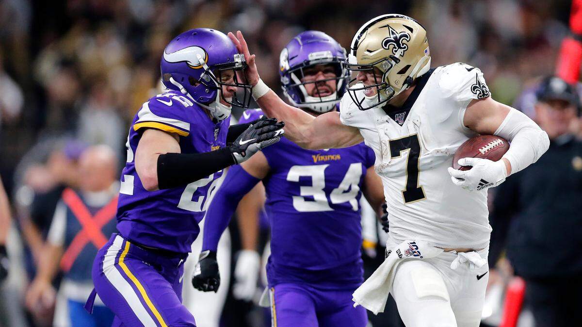 New Orleans Saints quarterback Taysom Hill (7) fends off Minnesota Vikings free safety Harrison Smith (22) on a long carry in the second half of an NFL wild-card playoff football game, Sunday, Jan. 5, 2020, in New Orleans. (AP Photo/Brett Duke)